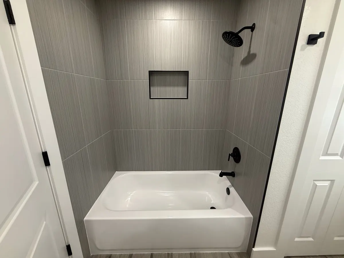 Remodeled bathroom with tiled tub and shower