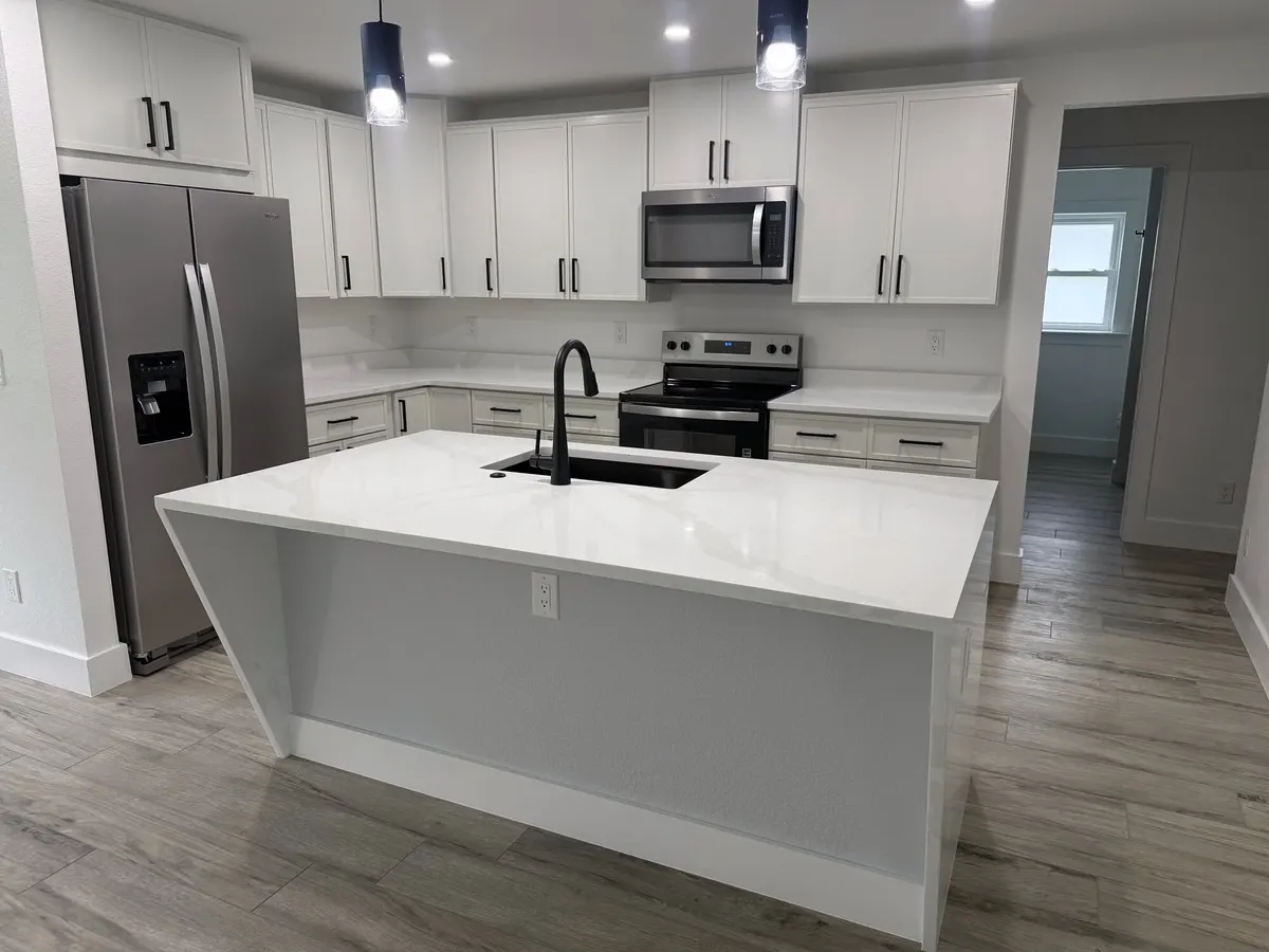 Remodeled white kitchen with large island
